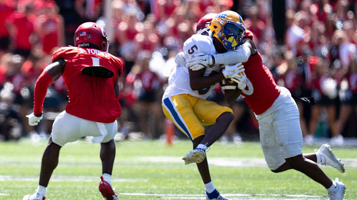 Cincinnati Bearcats defensive back Derrick Canteen (10) tackles Pittsburgh Panthers defensive back Phillip O'Brien Jr. (5) in the fourth quarter of the College Football game at Nippert Stadium in Cincinnati on Saturday, Sept. 7, 2024.