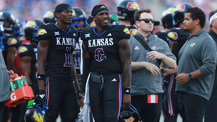 Kansas Jayhawks quarterback Jalon Daniels (6) watches a replay alongside Kansas Jayhawks wide receiver Emmanuel Henderson Jr. (1) during the first half of the game against West Virginia Mountaineers at David Booth Kansas Memorial Stadium on Sept. 20, 2025.