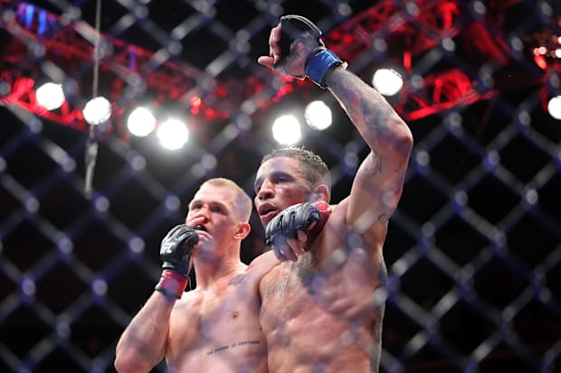 Ian Machado Garry (red gloves) reacts with Carlos Prates (blue gloves) after the fight during UFC Fight Night at T-Mobile Cen