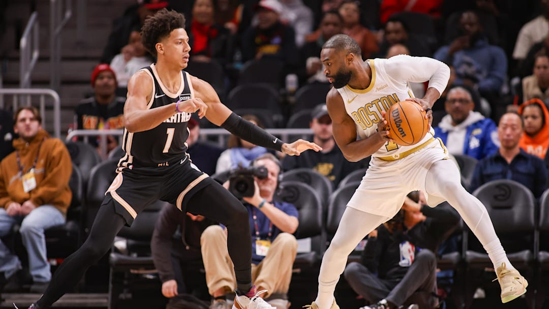 Jan 17, 2026; Atlanta, Georgia, USA; Atlanta Hawks forward Jalen Johnson (1) defends Boston Celtics guard Jaylen Brown (7) in the first quarter at State Farm Arena. Mandatory Credit: Brett Davis-Imagn Images
