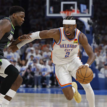 May 20, 2025; Oklahoma City, Oklahoma, USA; Oklahoma City Thunder guard Shai Gilgeous-Alexander (2) drives against Minnesota Timberwolves guard Anthony Edwards (5) in the fourth quarter during game one of the western conference finals for the 2025 NBA Playoffs at Paycom Center. Mandatory Credit: Alonzo Adams-Imagn Images