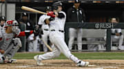 Chicago White Sox outfielder Andrew Benintendi (23) hits a three-run home run against the Los Angeles Angels at Rate Field.