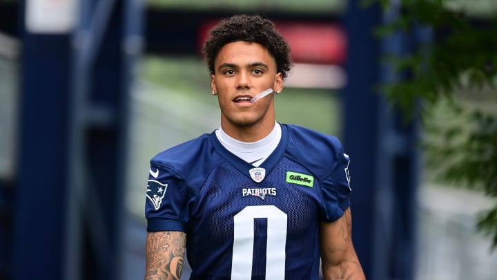 Jul 24, 2024; Foxborough, MA, USA; New England Patriots cornerback Christian Gonzalez (0) walks to the practice field during training camp at Gillette Stadium. Mandatory Credit: Eric Canha-USA TODAY Sports