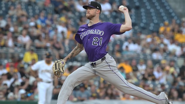 Freeland getting ready to release a ball off of the dirt mound wearing a purple jersey and grey pants