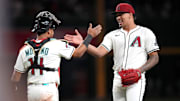 Arizona Diamondbacks closer Justin Martinez (63) high-fives teammate Gabriel Moreno (14) after their 4-3 win over the Baltimore Orioles at Chase Field in Phoenix on April 8, 2025.