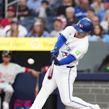 Toronto Blue Jays center fielder Daulton Varsho (25) hits a two-run home run against the Philadelphia Phillies during the first inning at Rogers Centre in 2024.