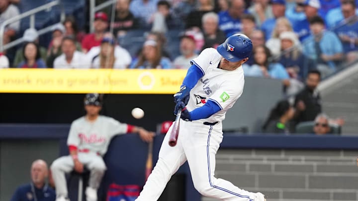 Toronto Blue Jays center fielder Daulton Varsho (25) hits a two-run home run against the Philadelphia Phillies during the first inning at Rogers Centre in 2024.