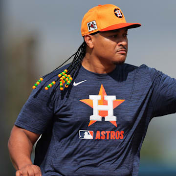 Feb 14, 2025; West Palm Beach, FL, USA; Houston Astros starting pitcher Luis Garcia (77) works on a fielding exercise during a spring training workout at CACTI Park of the Palm Beaches. 