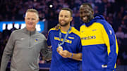 Oct 11, 2024; San Francisco, California, USA; Golden State Warriors guard Stephen Curry (center) is flanked by head coach Steve Kerr and forward Draymond Green as he is presented his gold medal for his performance for Team USA at the 2024 Summer Olympics in Paris before taking on the Sacramento Kings at Chase Center. Mandatory Credit: D. Ross Cameron-Imagn Images