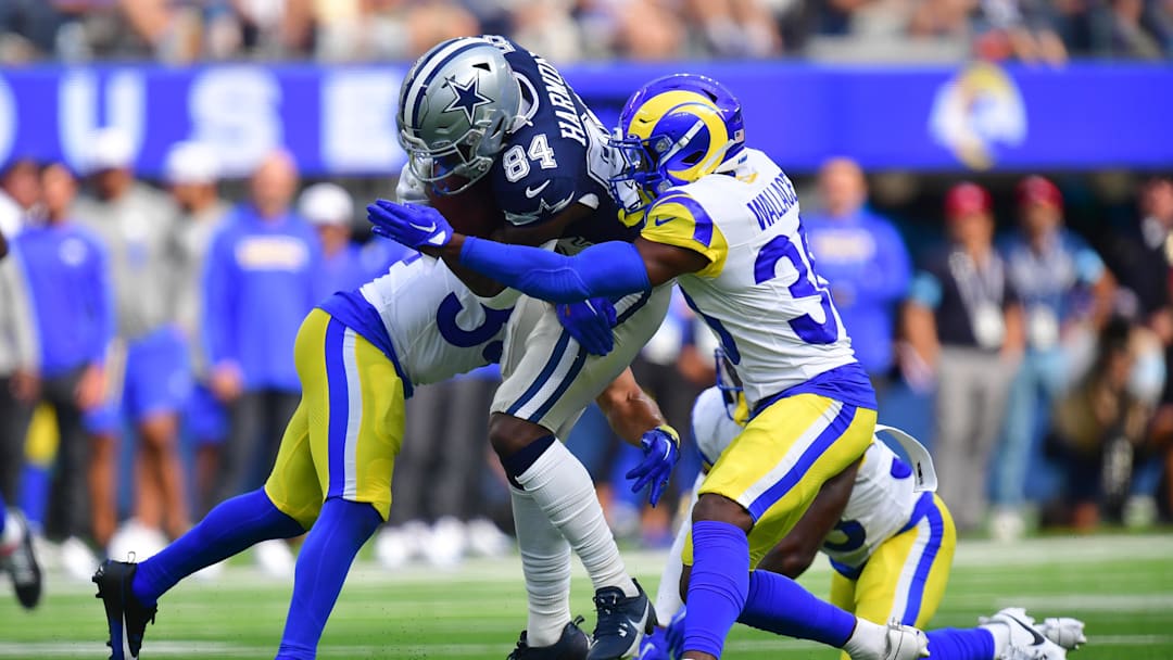 Aug 11, 2024; Inglewood, California, USA; Dallas Cowboys wide receiver Kelvin Harmon (84) runs the ball against Los Angeles Rams cornerback Josh Wallace (30) during the second half at SoFi Stadium. Mandatory Credit: Gary A. Vasquez-Imagn Images