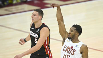 Apr 23, 2025; Cleveland, Ohio, USA; Cleveland Cavaliers guard Donovan Mitchell (45) shoots beside Miami Heat forward Nikola Jovic (5) in the fourth quarter of game two of the first round of the 2025 NBA Playoffs at Rocket Arena. Mandatory Credit: David Richard-Imagn Images