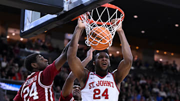 Mar 22, 2025; Providence, RI, USA; St. John's Red Storm forward Zuby Ejiofor (24) dunks against Arkansas Razorbacks forward Billy Richmond III (24) and guard Johnell Davis (1) during the second half of a second round men’s NCAA Tournament game at Amica Mutual Pavilion. Mandatory Credit: Brian Fluharty-Imagn Images
