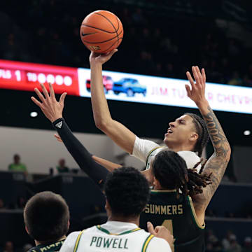 Dec 2, 2025; Waco, Texas, USA;  Baylor Bears guard Cameron Carr (43) scores a basket over Sacramento State Hornets guard Jahni Summers (4) during the first half at Paul and Alejandra Foster Pavilion. Mandatory Credit: Chris Jones-Imagn Images