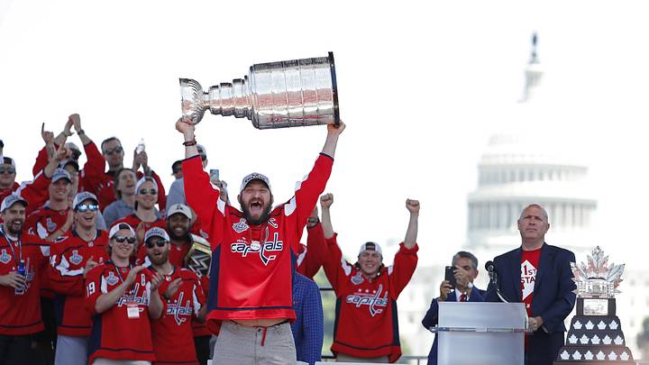 Jun 12, 2018; Washington, DC, USA; Washington Capitals left wing Alex Ovechkin (8) lifts the Stanley Cup during the Stanley Cup championship parade and celebration on the National Mall. Mandatory Credit: Geoff Burke-Imagn Images