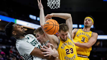 Michigan State forward Xavier Booker (34), forward Jaxon Kohler (0), Minnesota forward Parker Fox (23) and forward Dawson Garcia (3) battle for the rebound during the second half of Second Round of Big Ten tournament at Target Center in Minneapolis, Minn. on Thursday, March 14, 2024.