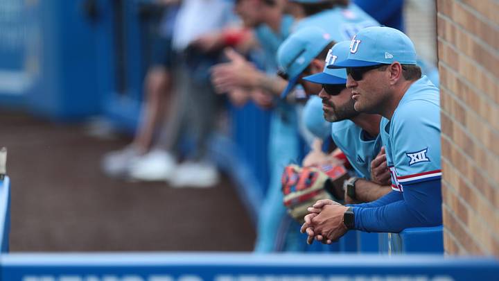 Kansas Jayhawks baseball coaches and players await the start of the game against Wichita State at Hoglund Ballpark on April 14, 2026.