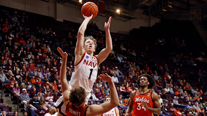 Dec 15, 2024; Blacksburg, Virginia, USA; Navy Midshipmen guard Austin Benigni (1) shoots the ball against Virginia Tech Hokies guard Jaden Schutt (2) during the second half at Cassell Coliseum. Dec 15, 2024; Blacksburg, Virginia, USA; Navy Midshipmen guard Austin Benigni (1) shoots the ball against Virginia Tech Hokies guard Jaden Schutt (2) during the second half at Cassell Coliseum.