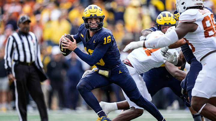 Michigan quarterback Davis Warren (16) keeps the ball for a run against Texas during the second half at Michigan Stadium in Ann Arbor on Saturday, September 7, 2024.