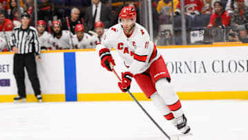 Dec 23, 2024; Nashville, Tennessee, USA;  Carolina Hurricanes center Jordan Staal (11) skates with the puck against the Nashville Predators during the first period at Bridgestone Arena. Mandatory Credit: Steve Roberts-Imagn Images