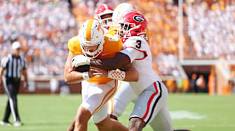 Sep 13, 2025; Knoxville, Tennessee, USA; Tennessee Volunteers quarterback Joey Aguilar (6) run the ball as Georgia Bulldogs linebacker CJ Allen (3) defends during the first half at Neyland Stadium. Mandatory Credit: Alan Poizner-Imagn Images