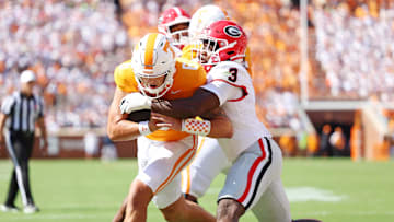 Sep 13, 2025; Knoxville, Tennessee, USA; Tennessee Volunteers quarterback Joey Aguilar (6) run the ball as Georgia Bulldogs linebacker CJ Allen (3) defends during the first half at Neyland Stadium. Mandatory Credit: Alan Poizner-Imagn Images