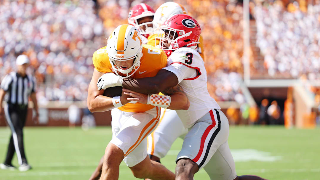 Sep 13, 2025; Knoxville, Tennessee, USA; Tennessee Volunteers quarterback Joey Aguilar (6) run the ball as Georgia Bulldogs linebacker CJ Allen (3) defends during the first half at Neyland Stadium. Mandatory Credit: Alan Poizner-Imagn Images