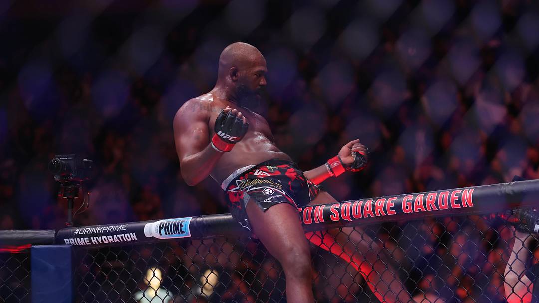 Nov 16, 2024; New York, NY, USA; Jon Jones (red gloves) celebrates defeating Stipe Miocic (blue gloves) in the heavyweight bout during UFC 309 at Madison Square Garden. Mandatory Credit: Brad Penner-Imagn Images