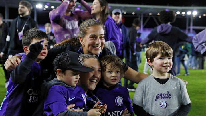Nov 23, 2024; Kansas City, Missouri, USA; Orlando Pride forward Summer Yates (28) and defender Kerry Abello (25) celebrate after winning the 2024 NWSL Championship match at CPKC Stadium. Mandatory Credit: Kylie Graham-Imagn Images