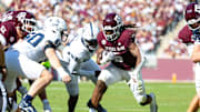 Nov 22, 2025; College Station, Texas, USA; Texas A&M Aggies running back Amari Daniels (5) runs with the ball in the first half of a game against the Samford Bulldogs at Kyle Field. Mandatory Credit: Joseph Buvid-Imagn Images