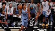 Nov 4, 2024; Brooklyn, New York, USA; Memphis Grizzlies guard Ja Morant (12) drives to the basket against Brooklyn Nets center Nic Claxton (33) during the fourth quarter at Barclays Center. Mandatory Credit: Brad Penner-Imagn Images