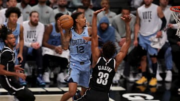 Nov 4, 2024; Brooklyn, New York, USA; Memphis Grizzlies guard Ja Morant (12) drives to the basket against Brooklyn Nets center Nic Claxton (33) during the fourth quarter at Barclays Center. Mandatory Credit: Brad Penner-Imagn Images