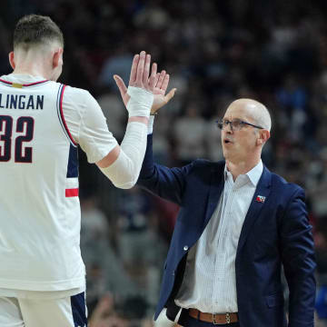 Apr 6, 2024; Glendale, AZ, USA; Connecticut Huskies head coach Dan Hurley high fives center Donovan Clingan (32) as he exits the game against the Alabama Crimson Tide during the second half in the semifinals of the men's Final Four of the 2024 NCAA Tournament at State Farm Stadium. Mandatory Credit: Bob Donnan-USA TODAY Sports