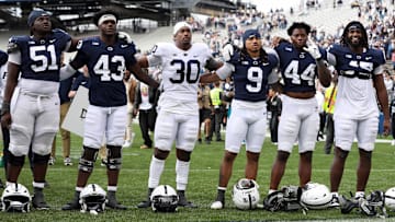 Penn State football players sing their alma mater following the Blue-White Spring Game at Beaver Stadium