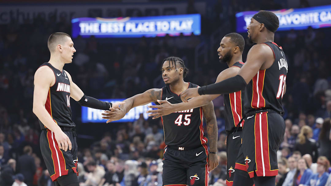Feb 12, 2025; Oklahoma City, Oklahoma, USA; Miami Heat guard Tyler Herro (14), guard Davion Mitchell (45), forward Andrew Wiggins (22) and center Bam Adebayo (13) high five after a play against the Oklahoma City Thunder during the first quarter at Paycom Center. Mandatory Credit: Alonzo Adams-Imagn Images Feb 12, 2025; Oklahoma City, Oklahoma, USA; Miami Heat guard Tyler Herro (14), guard Davion Mitchell (45), forward Andrew Wiggins (22) and center Bam Adebayo (13) high five after a play against the Oklahoma City Thunder during the first quarter at Paycom Center. Mandatory Credit: Alonzo Adams-Imagn Images