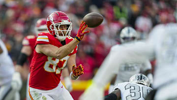 Nov 29, 2024; Kansas City, Missouri, USA; Kansas City Chiefs tight end Travis Kelce (87) laterals the ball during the first half against the Las Vegas Raiders at GEHA Field at Arrowhead Stadium. Mandatory Credit: Jay Biggerstaff-Imagn Images