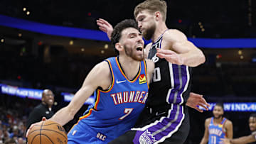 Apr 9, 2024; Oklahoma City, Oklahoma, USA; Oklahoma City Thunder forward Chet Holmgren (7) reacts as he is defended by Sacramento Kings forward Domantas Sabonis (10) during the second half at Paycom Center. Mandatory Credit: Alonzo Adams-Imagn Images