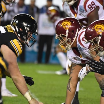 Dec 27, 2019; San Diego, California, USA; General overall view of the line of scrimmage as Iowa Hawkeyes offensive lineman Tyler Linderbaum (65) snaps the ball against the Southern California Trojans during the Holiday Bowl at SDCCU Stadium. Iowa defeated USC 49-24.  Mandatory Credit: Kirby Lee-USA TODAY Sports