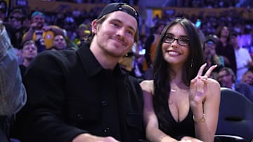 Oct 24, 2025; Los Angeles, California, USA; Los Angeles Chargers quarterback Justin Herbert (left) and girlfriend Madison Beer attend the game between the Minnesota Timberwolves and the Los Angeles Lakers at Crypto.com Arena. Mandatory Credit: Kirby Lee-Imagn Images