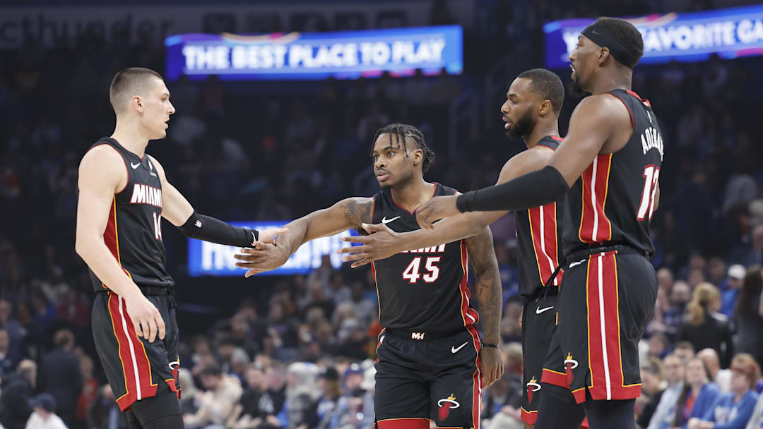 Feb 12, 2025; Oklahoma City, Oklahoma, USA; Miami Heat guard Tyler Herro (14), guard Davion Mitchell (45), forward Andrew Wiggins (22) and center Bam Adebayo (13) high five after a play against the Oklahoma City Thunder during the first quarter at Paycom Center. Mandatory Credit: Alonzo Adams-Imagn Images
