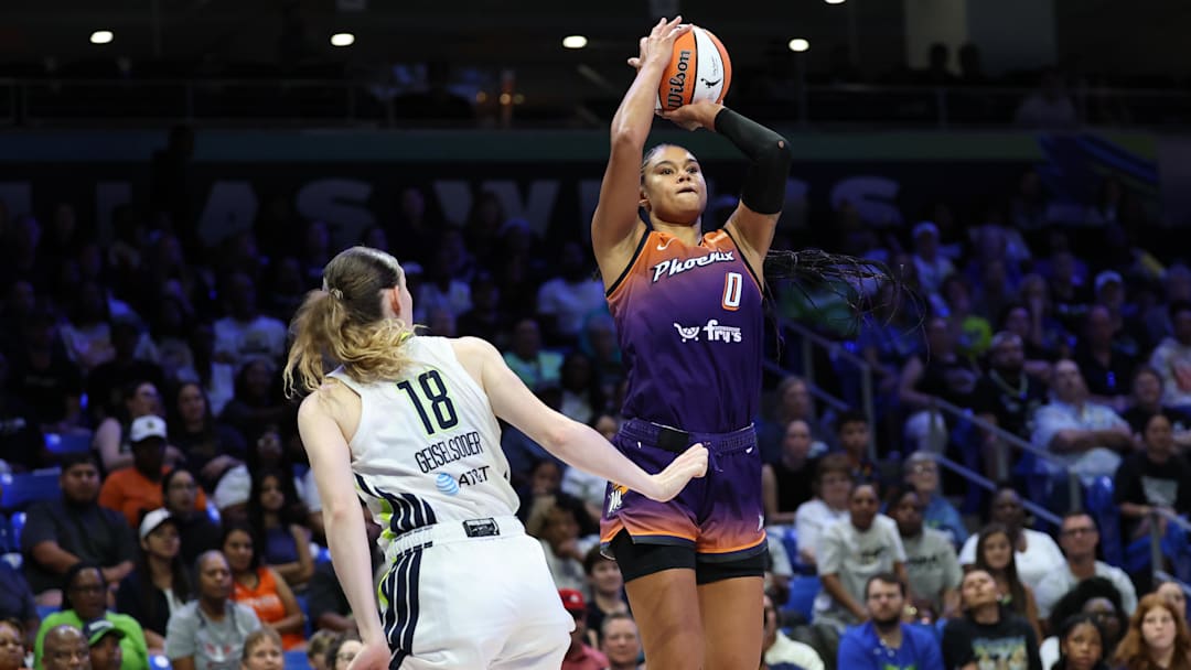 Jul 3, 2025; Arlington, Texas, USA;  Phoenix Mercury forward Satou Sabally (0) shoots over Dallas Wings center Luisa Geiselsoder (18) during the second half at College Park Center. Mandatory Credit: Kevin Jairaj-Imagn Images