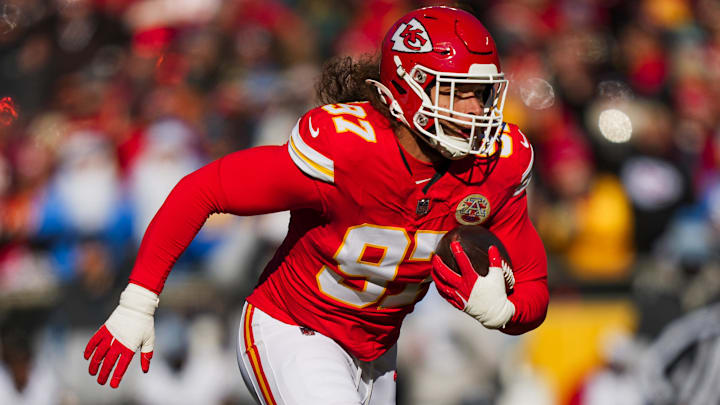 Dec 14, 2025; Kansas City, Missouri, USA; Kansas City Chiefs defensive end Ashton Gillotte (97) returns an interception against the Los Angeles Chargers during the second quarter at GEHA Field at Arrowhead Stadium.
