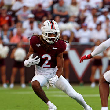 Sep 21, 2024; Blacksburg, Virginia, USA; Virginia Tech Hokies wide receiver Takye Heath (2) runs the ball against Rutgers Scarlet Knights defensive back Bo Mascoe (3) during the fourth quarter at Lane Stadium. Mandatory Credit: Peter Casey-Imagn Images