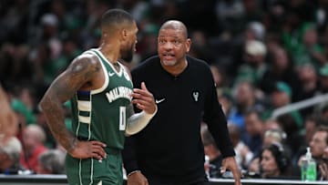 Oct 28, 2024; Boston, Massachusetts, USA; Milwaukee Bucks head coach Doc Rivers talks to Milwaukee Bucks guard Damian Lillard (0) during the first half against the Boston Celtics at TD Garden. Mandatory Credit: Paul Rutherford-Imagn Images