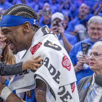 Oklahoma City Thunder guard Shai Gilgeous-Alexander (2) hugs his son and wife.