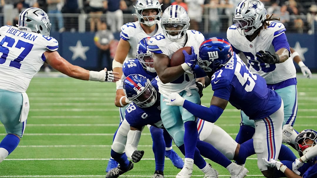 Sep 14, 2025; Arlington, Texas, USA; Dallas Cowboys running back Javonte Williams (33) runs with the ball against New York Giants linebacker Bobby Okereke (58) and defensive end Chauncey Golston (57) during overtime at AT&T Stadium. Mandatory Credit: Raymond Carlin III-Imagn Images