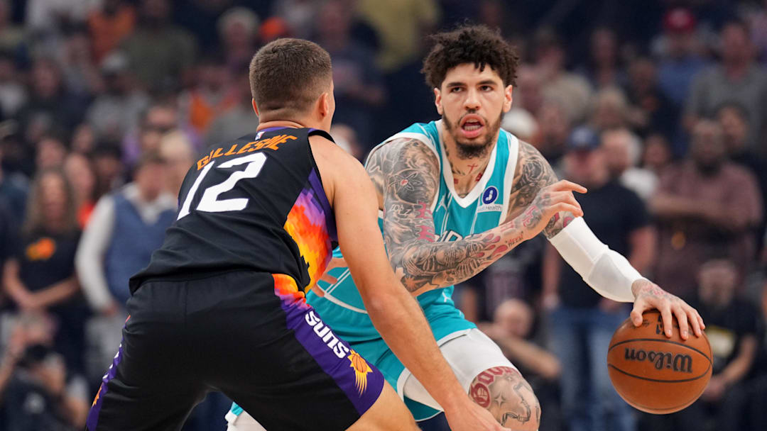 Mar 8, 2026; Phoenix, Arizona, USA; Charlotte Hornets guard LaMelo Ball (1) dribbles against Phoenix Suns guard Collin Gillespie (12) during the first half at Mortgage Matchup Center. Mandatory Credit: Joe Camporeale-Imagn Images