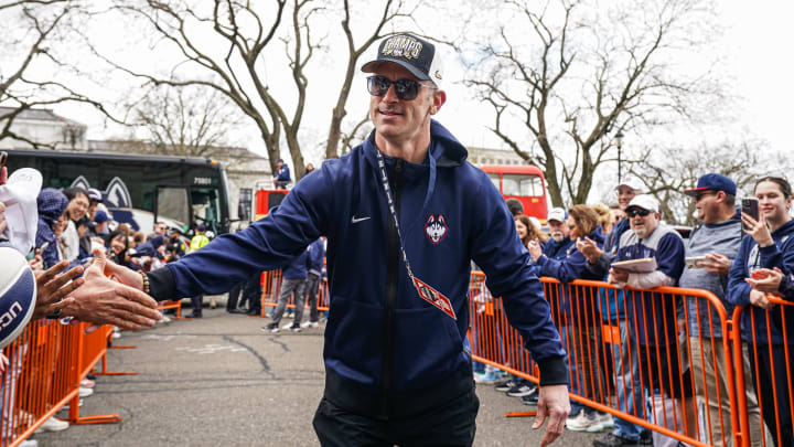 UConn Huskies head coach Dan Hurley is greeted by fans as he and his team arrive at the State Capitol before the NCAA Men's Basketball Championship victory parade. UConn Huskies head coach Dan Hurley is greeted by fans as he and his team arrive at the State Capitol before the NCAA Men's Basketball Championship victory parade.