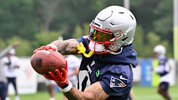 Jun 9, 2025; Foxborough, MA, USA; New England Patriots cornerback Christian Gonzalez (0) catches the ball during minicamp at Gillette Stadium. Mandatory Credit: Eric Canha-Imagn Images