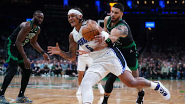 Boston Celtics forward Jayson Tatum defends against Orlando Magic forward Paolo Banchero.