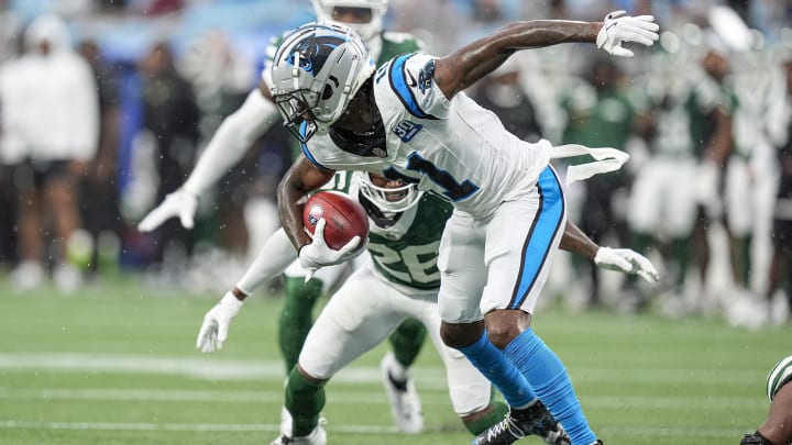 Aug 17, 2024; Charlotte, North Carolina, USA; Carolina Panthers wide receiver Ihmir Smith-Marsette tries to elude New York Jets cornerback Brandin Echols (26) during the first quarter at Bank of America Stadium. 